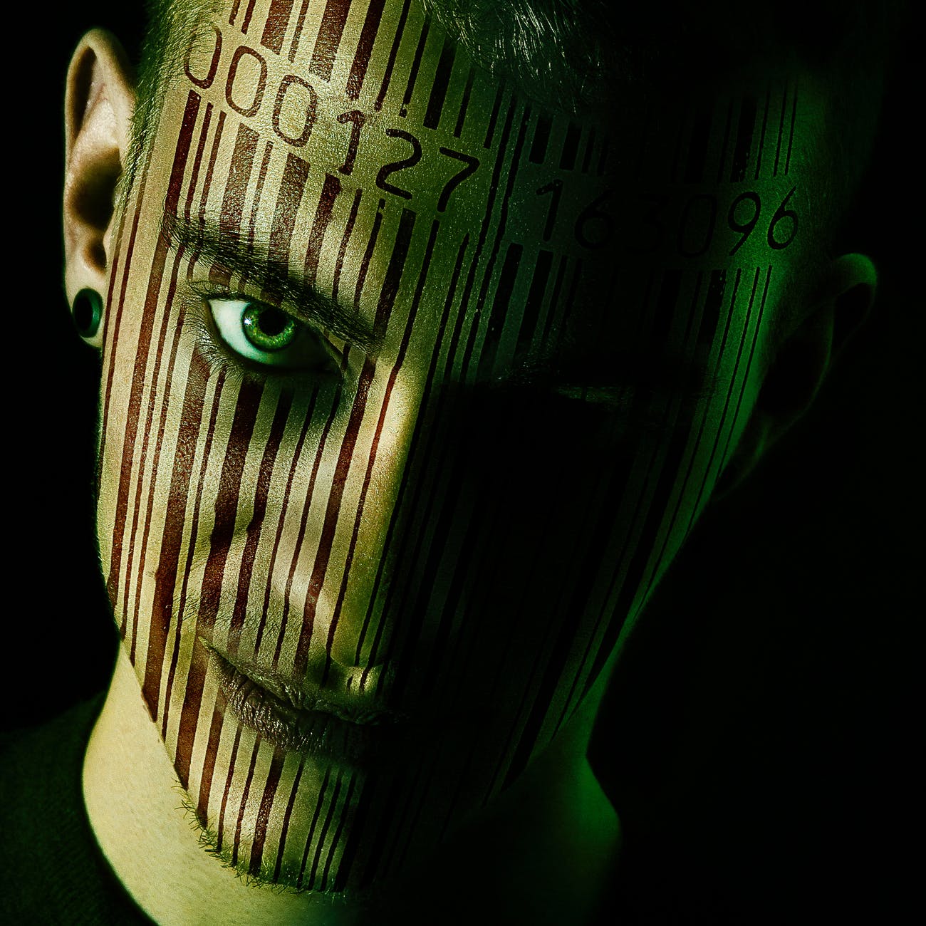 man s face with barcode